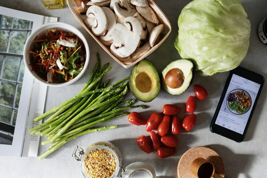 Colorful fresh vegetables, grains, and proteins arranged for healthy meal prep planning on a kitchen counter